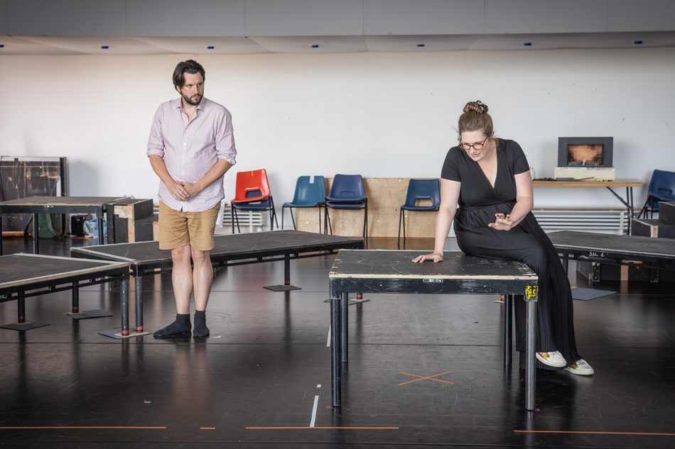 A man and woman singing in the rehearsal room