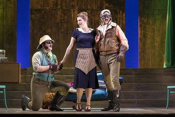 Ferrando and Guglielmo sing with Despina. Ferrando is on his knees holding Despina's hand.