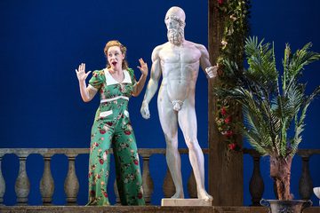 Dorabella is behaving playfully in front of a statue of a naked man