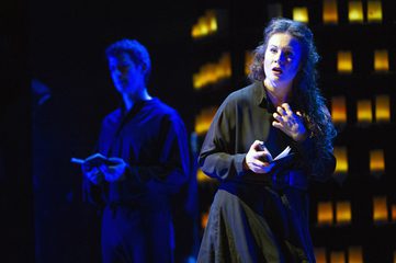 Belinda is holding a book and clutching her hand to her chest. The Sailor is in the background holding a book.