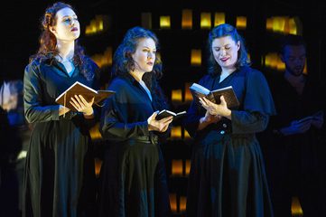 Dido, Belinda and second woman are all wearing black and holding books. Dido and Belinda are looking in to the distant