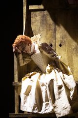 Elizabeth I holding head in hand, on throne