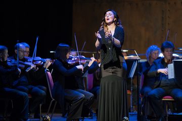 Opera singer in front of orchestra