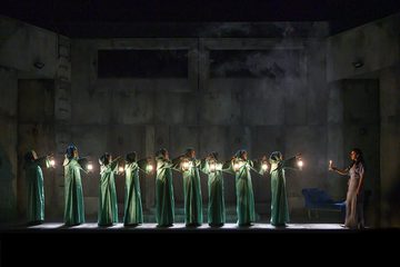 Line of witches with lanterns watching Lady Macbeth sleepwalk