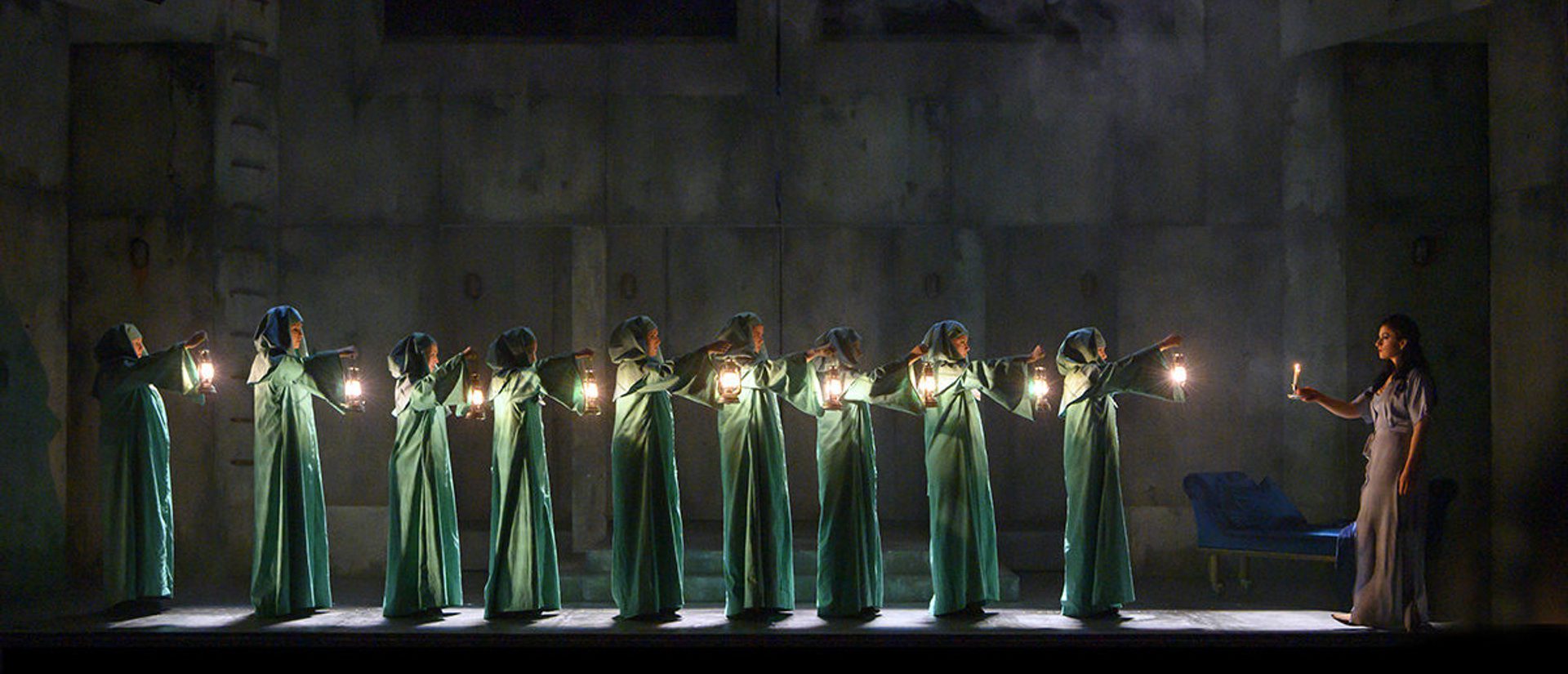 Line of witches with lanterns watching Lady Macbeth sleepwalk