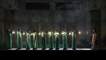 Line of witches with lanterns watching Lady Macbeth sleepwalk